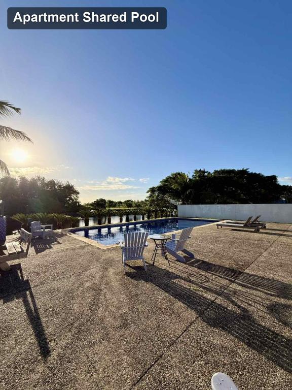 a group of chairs sitting next to a swimming pool at Bountiful Estates Fantasy in Nadi