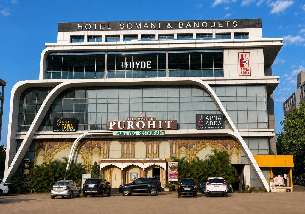 a large building with cars parked in front of it at Hotel Somani Wakad in Méribel Village