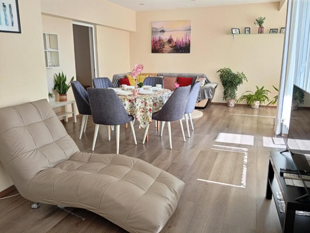 a living room with a table and chairs at Grand Central Varna in Varna City