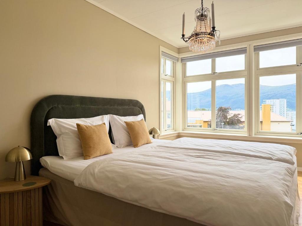 a bedroom with a bed with a large window at Charming apartment with free parking close to Ålesund center in Ålesund