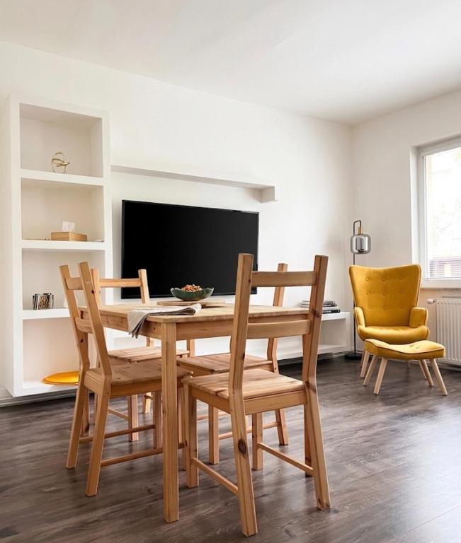 a dining room with a wooden table and chairs at Apartman na konci světa Hřensko in Hřensko