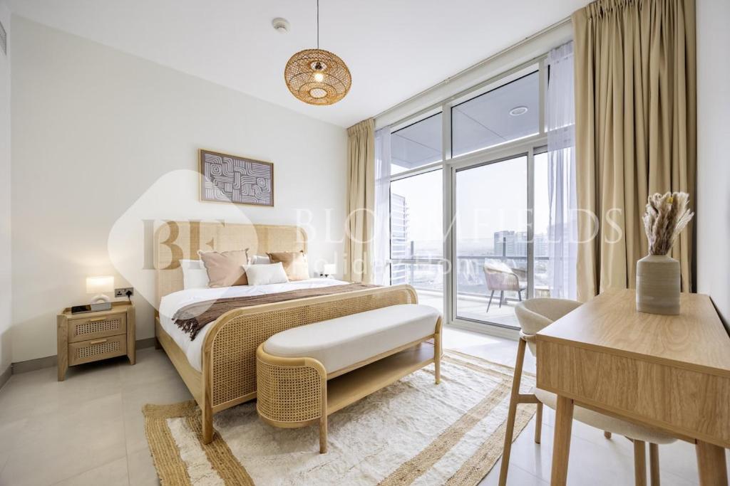 a bedroom with a bed and a large window at Bloomfields 2BR in Lamar Raha Beach in Abu Dhabi