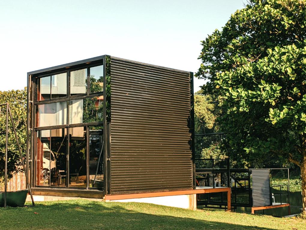 a small house with a large window at FREESCAPE Quiet Reset - Lakeside Mountainview in Cavinti