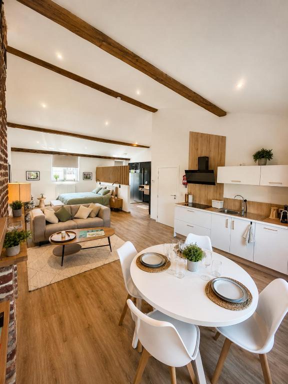 a kitchen and living room with a table and chairs at Station 33 in Spa