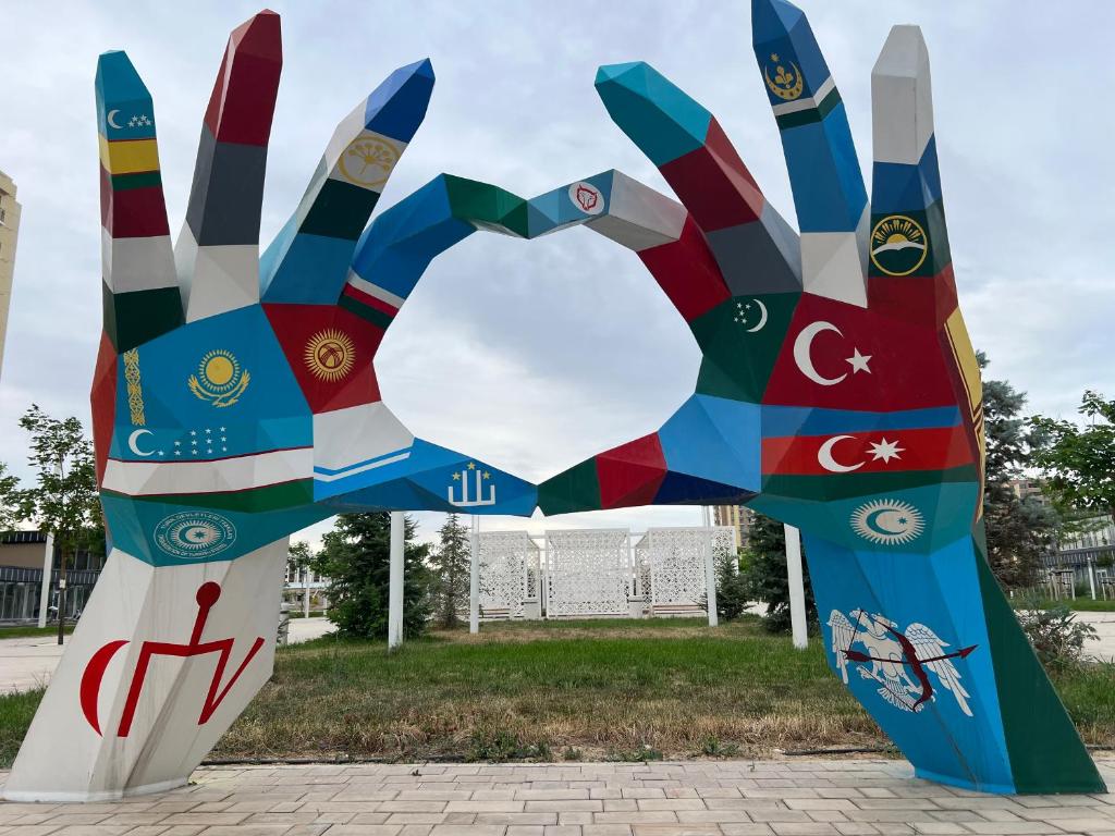 a sculpture of a hand made out of different countries at Turkish Muscat hostel in Muscat