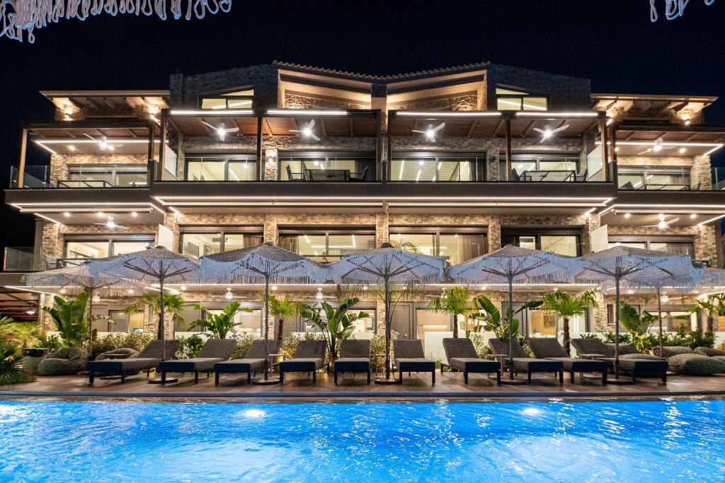 a hotel with a swimming pool at night at September15 Boutique Suites - Nikiana in Nikiana