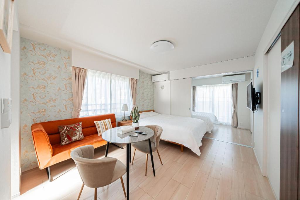 a hotel room with a bed and a table at Maple Hotel Tokyo in Tokyo