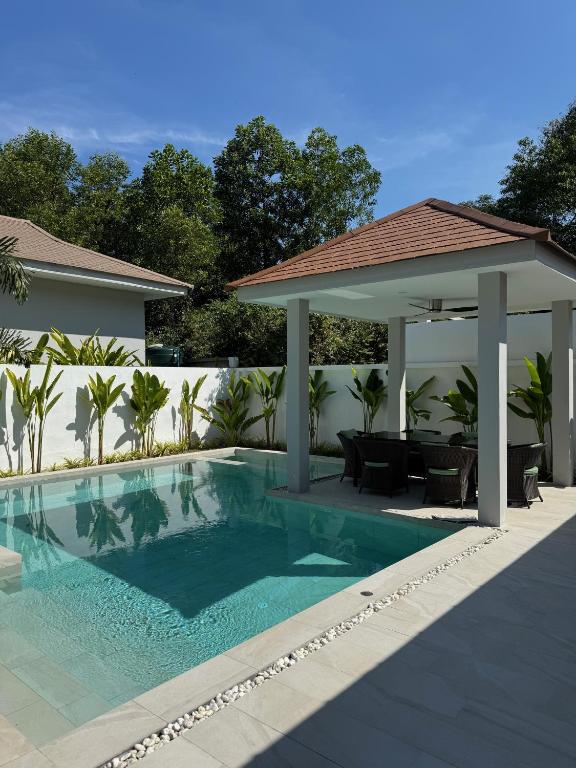 a swimming pool with a gazebo next to a house at Villa Palm Sip Sam in Ko Phangan