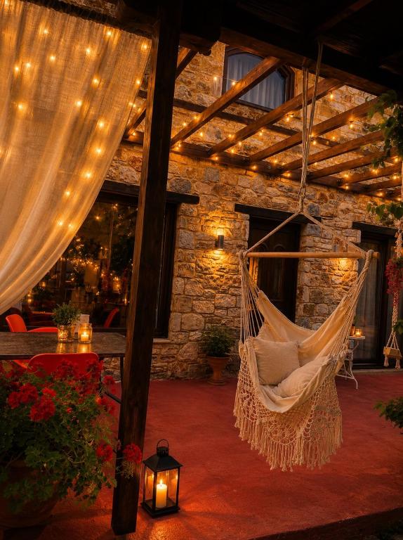 a hammock in a room with a stone wall at Villa Aggeliki in Prinos