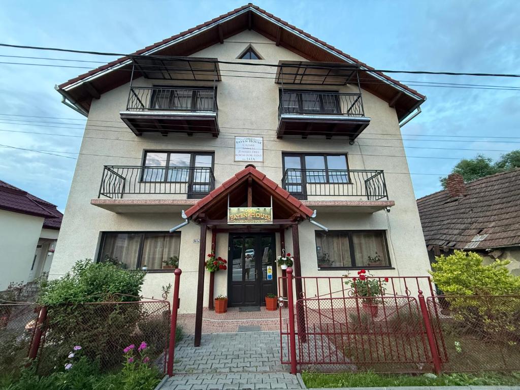 a house with a gate in front of it at Gold Fayen House Cheile Turului in Tureni