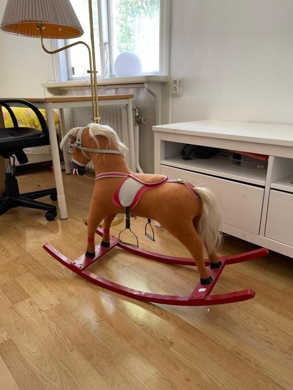 a toy horse on a sled in a room at 5ans rum Gunghästen in Skellefteå