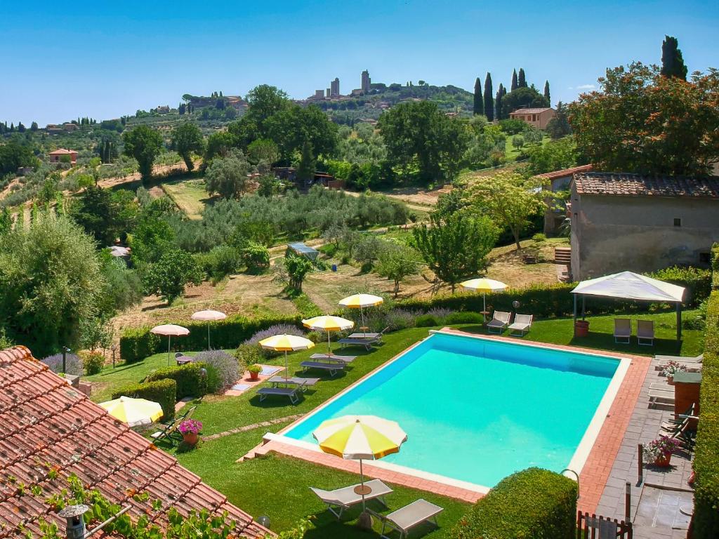 a view of a swimming pool with umbrellas at Hotel San Michele in San Gimignano