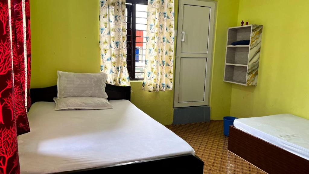 a small room with two beds and a window at Two in One Restaurant & Lodge in Pokhara