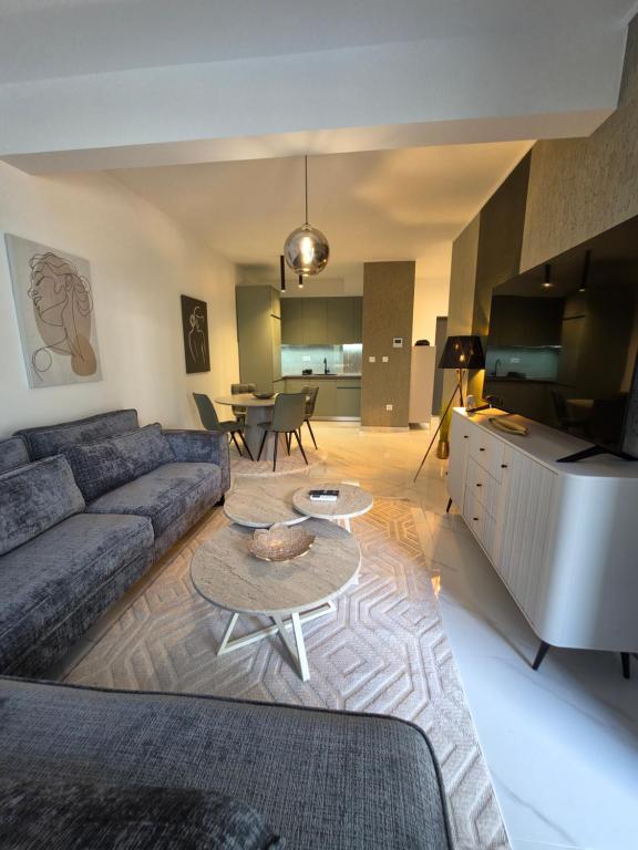a living room with a couch and two tables at Eclipse Luxury Suite in Šušanj
