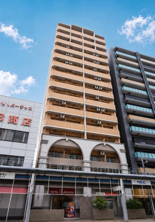 a tall apartment building with windows at Hotel Arashi Nippombashi 2 No008 in Osaka