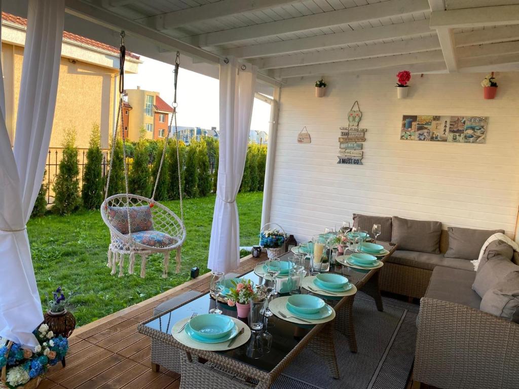 a patio with a table and a couch at Casa 18 in Sveti Vlas