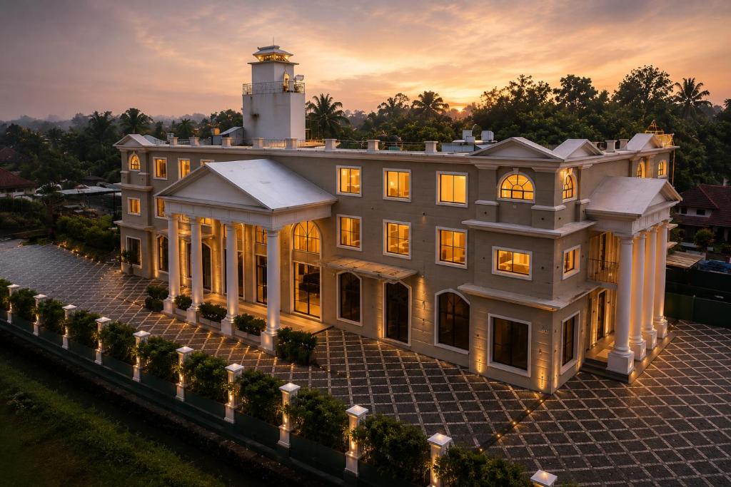 a large house with a lighthouse on top of it at raj Regent kurichy in Putuppalli