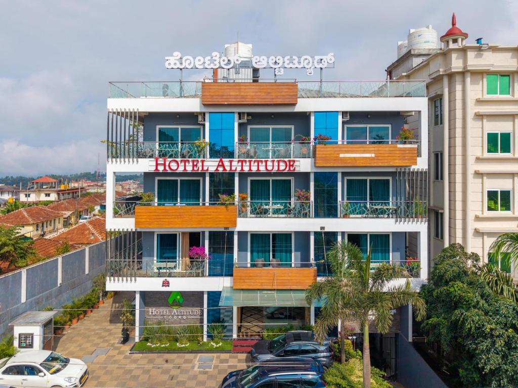 a hotel with a hotel attitude sign on a building at Hotel Altitude Coorg in Madikeri