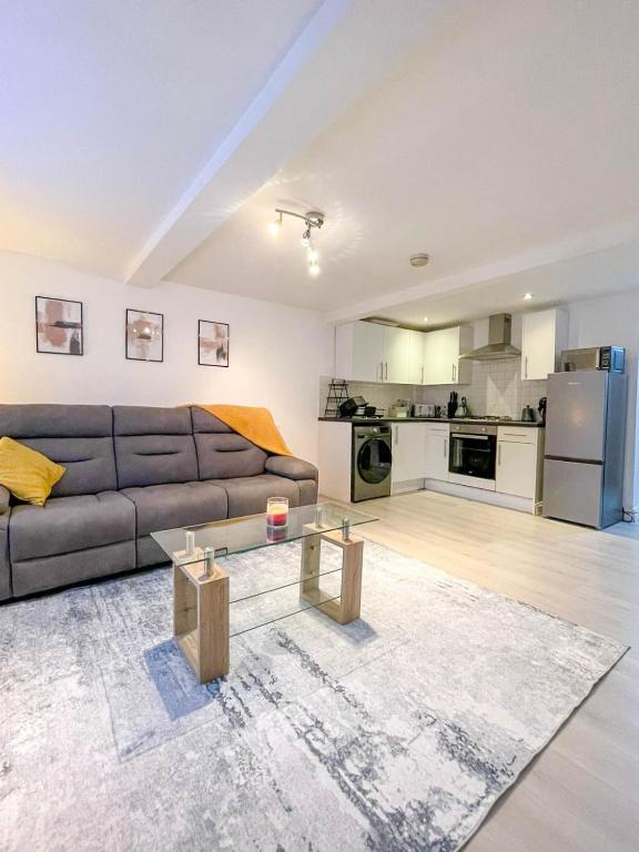 a living room with a couch and a table at Charming 1-Bed on High St in Longwell Green