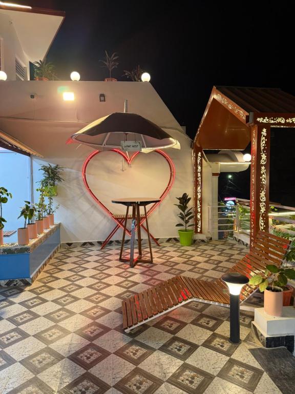 a table with a surfboard on top of a patio at Colonel Cottage in Prayagraj