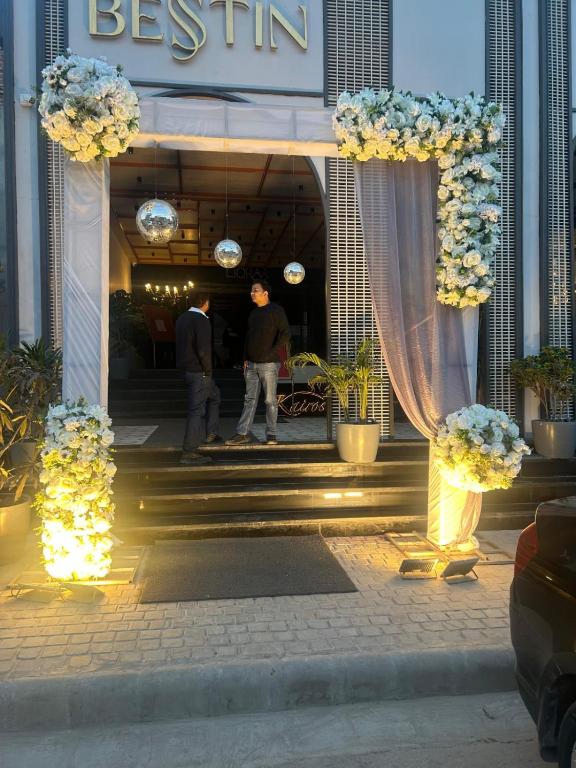 a entrance to a hotel with a bunch of flowers at Besstin Hotel in Hisār