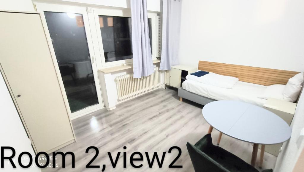 a room with a bed and a couch and a window at Neu-Isenburg in Neu Isenburg