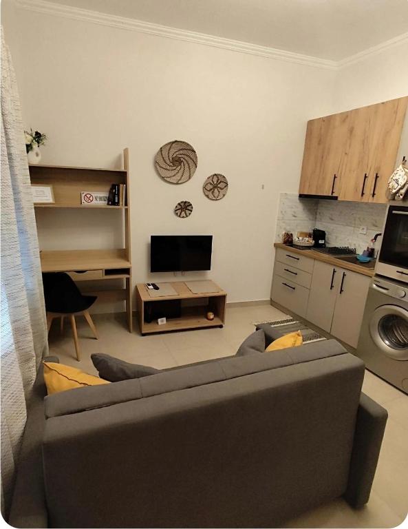 a living room with a couch and a tv at Lydia's Apartment in Tripoli