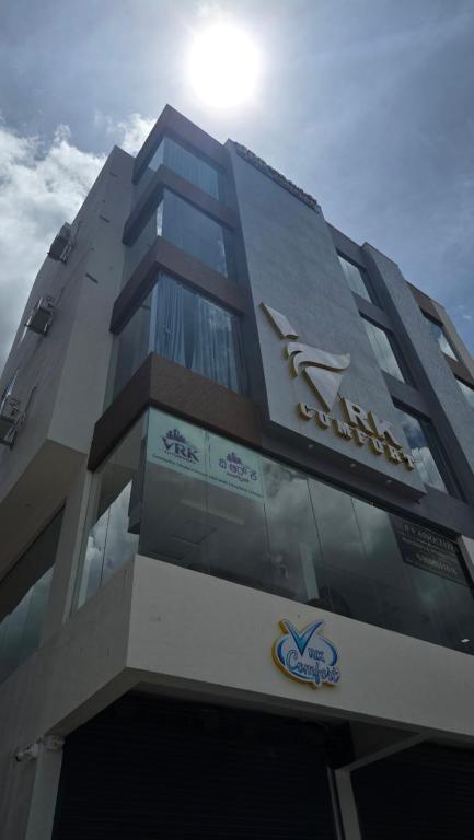 a building with a sign on the side of it at VRK Comfort in Mysore