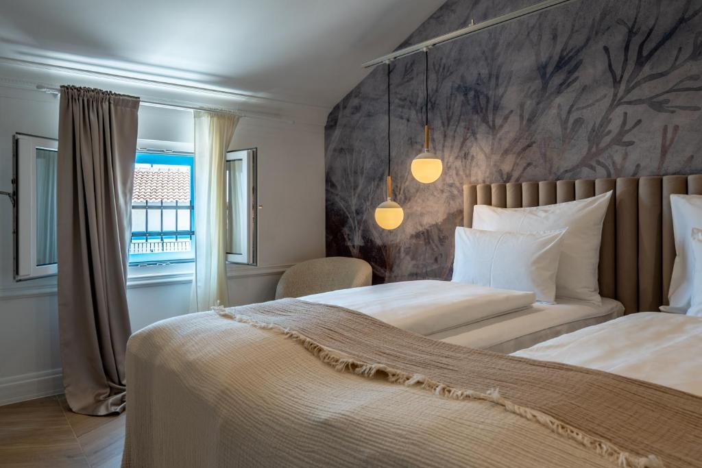 a bedroom with two beds and a wall at Agava Design Residence in Split