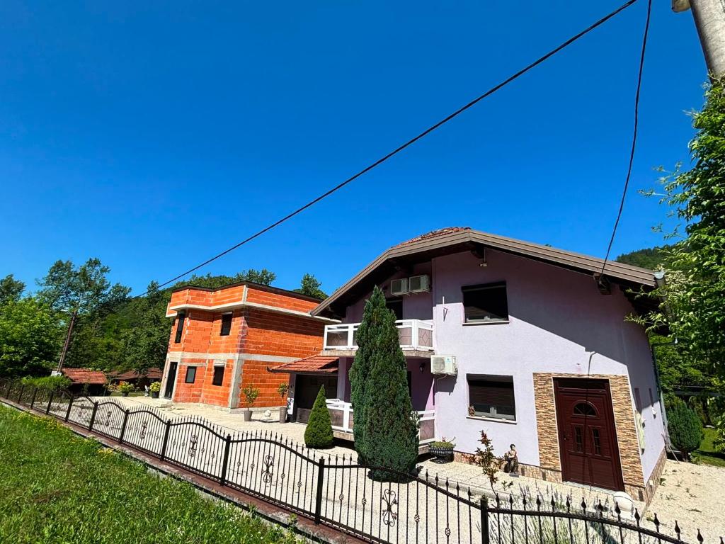 a house with a fence in front of it at EMRAH RIVER UNA in Bihać