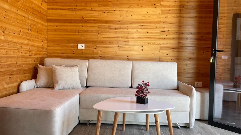 a living room with a couch and a table at IL Paradiso in Kavajë