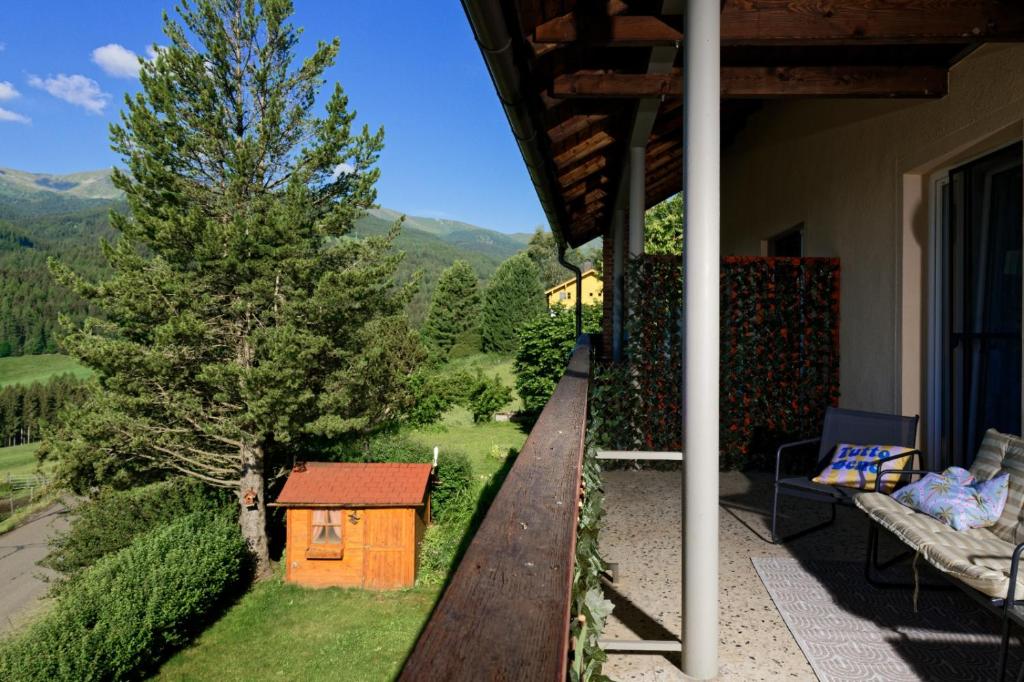 a small house sitting on the porch of a house at Zirbitzblick in Mönchegg