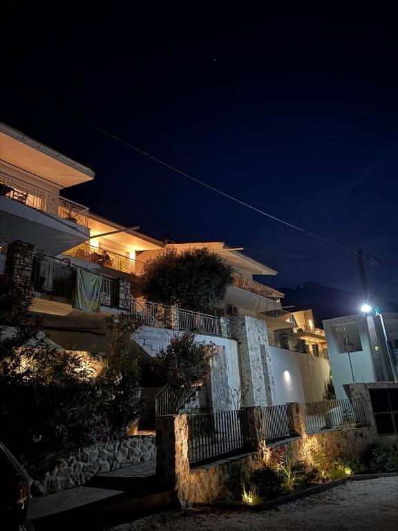 a building with a street light in front of it at night at Dimitra Beach Apartments - Thassos Skala Potamias in Skala Potamias