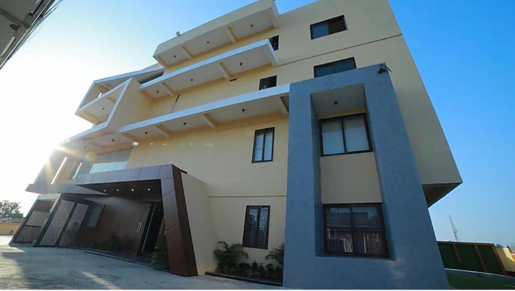 a large white building with a lot of windows at HOTEL The Breeze in Pachamba