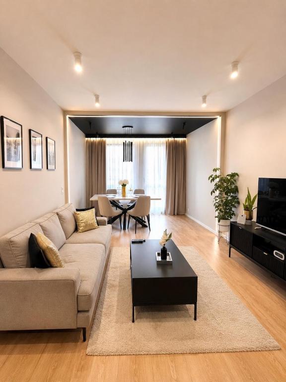 a living room with a couch and a table at Apartment BEIGE Exclusive in Piekary Śląskie
