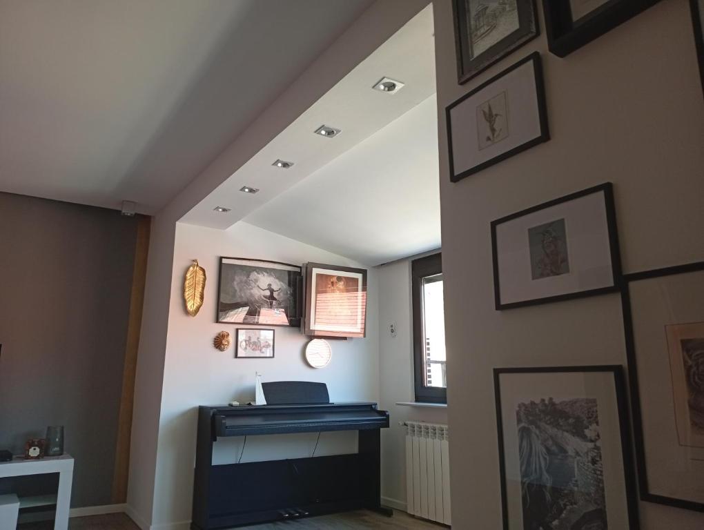 a living room with a fireplace and pictures on the wall at Apartman DALIAROSE Sarajevo in Sarajevo