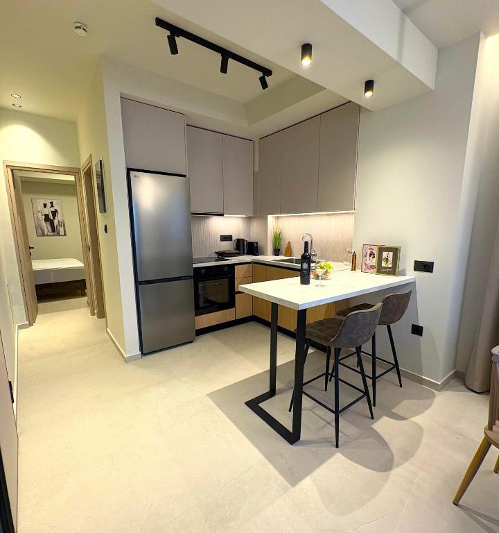 a kitchen with a table and chairs and a refrigerator at House 29 Suites in Heraklio