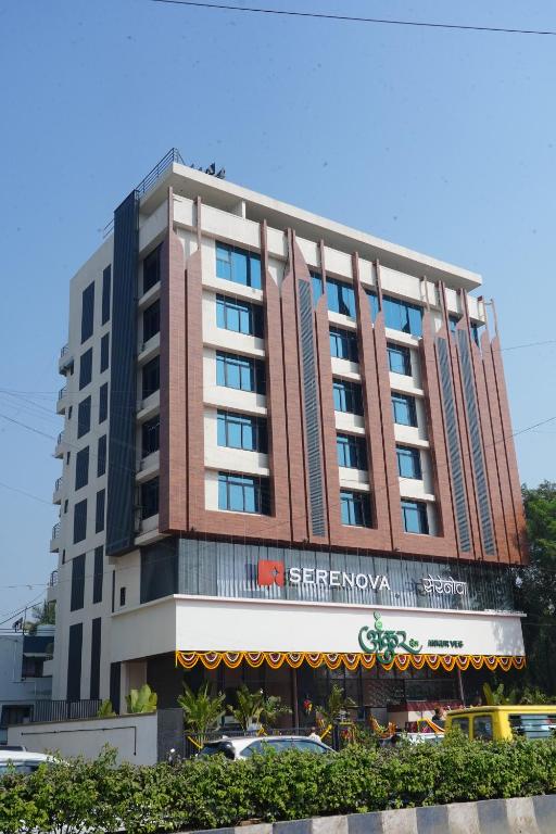 a tall building with a sign on it at Hotel Serenova, Pune- Pure Veg in Pune
