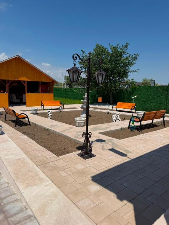 a park with benches and a street light and a lamp at Casa Aylin in Corbu
