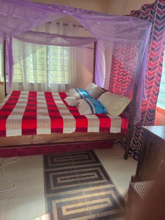 a bedroom with a bed with a canopy at Shalma House in Lamu