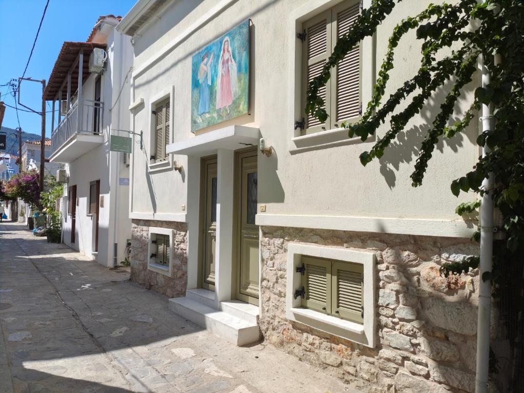 a building with a painting on the side of it at Cicones Boutique Apartments in Skiathos