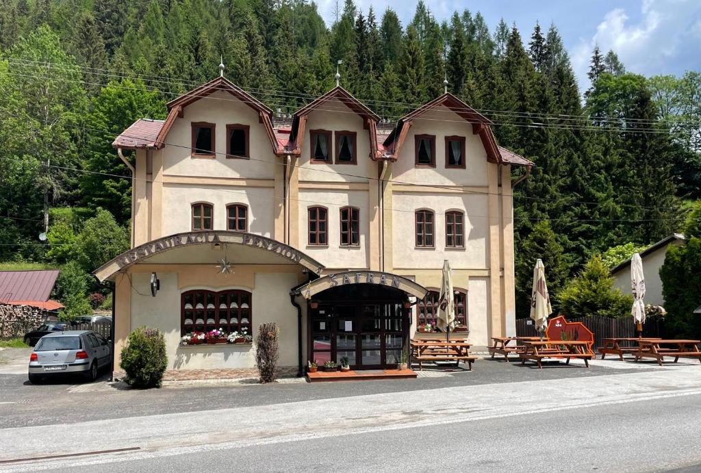 a building with a store on the side of the street at Penzión Šafran Stratená in Stratená