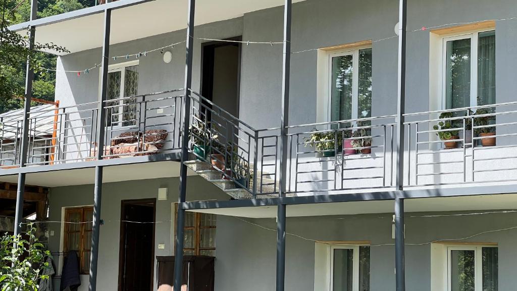 an external view of a building with balconies at Cozy Corner Inn in Ushkhvanari