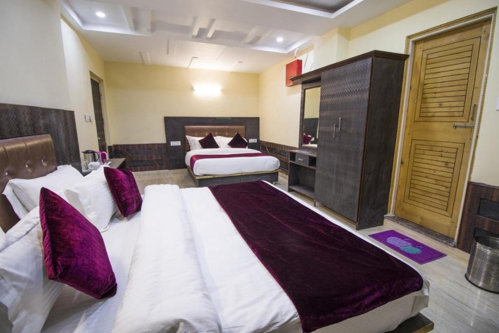 a large bedroom with two beds and a bathroom at AYUSHKAMA COTTAGE #Naddi Sunset Point#Free Parking#cricket stadium8 km#Mcleodganj 2 km- Bhagsunag 4 km in Dharamshala