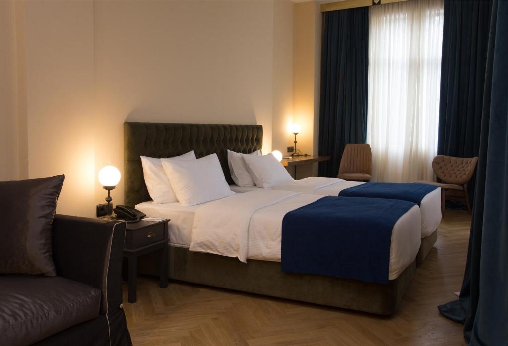 Postel nebo postele na pokoji v ubytování Museum Hotel