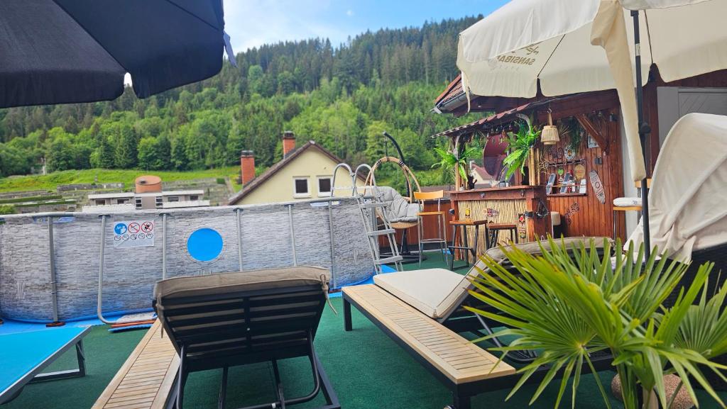 a patio with chairs and a fence and a pool at Miuti Residence in Triberg