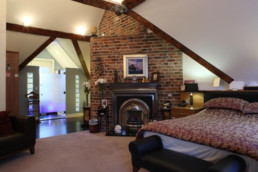 a bedroom with a brick fireplace and a bed at The Merchant House in Dublin