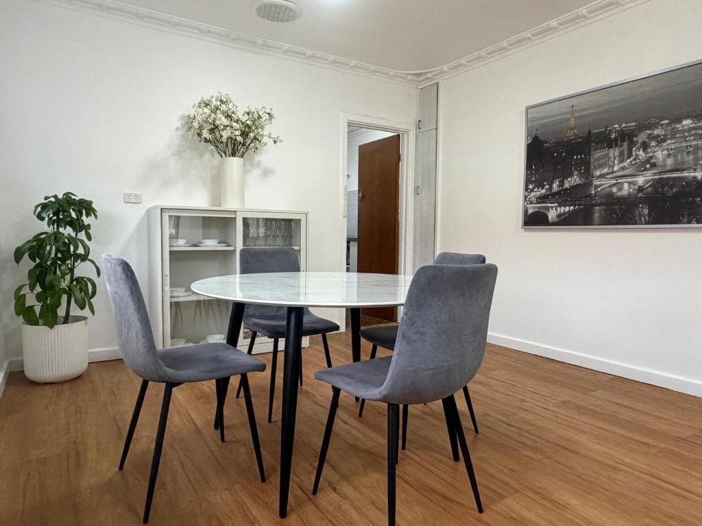 a dining room with a table and chairs at Como Beach Apartment 2 in Perth