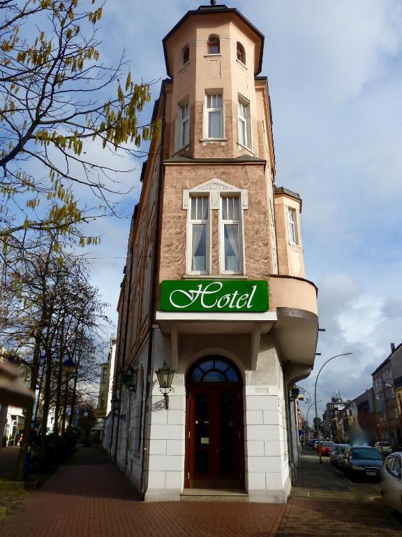 a building with a clock tower on top of it at Hotel Zum Bügeleisen in Duisburg