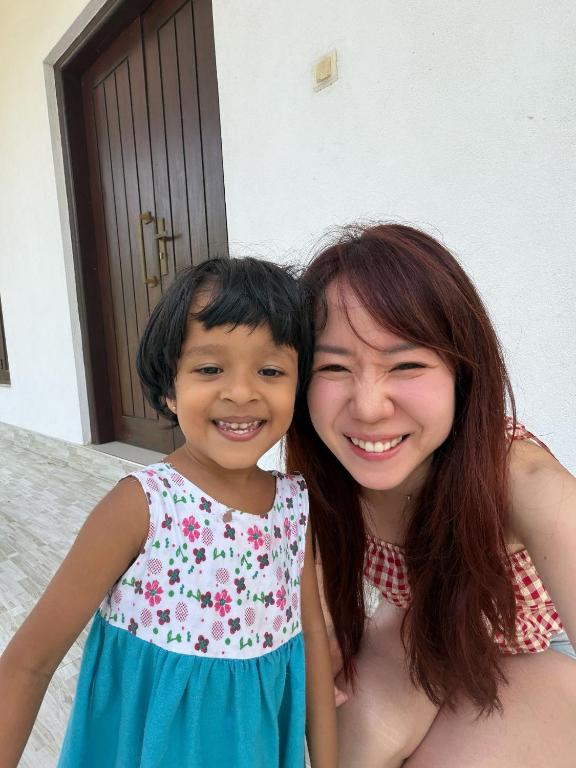 a woman and a little girl posing for a picture at Risenlak Holiday Resort in Polonnaruwa